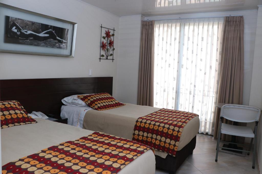 Postel nebo postele na pokoji v ubytování Hoteles Bogotá Inn Lago Chico Zona Rosa
