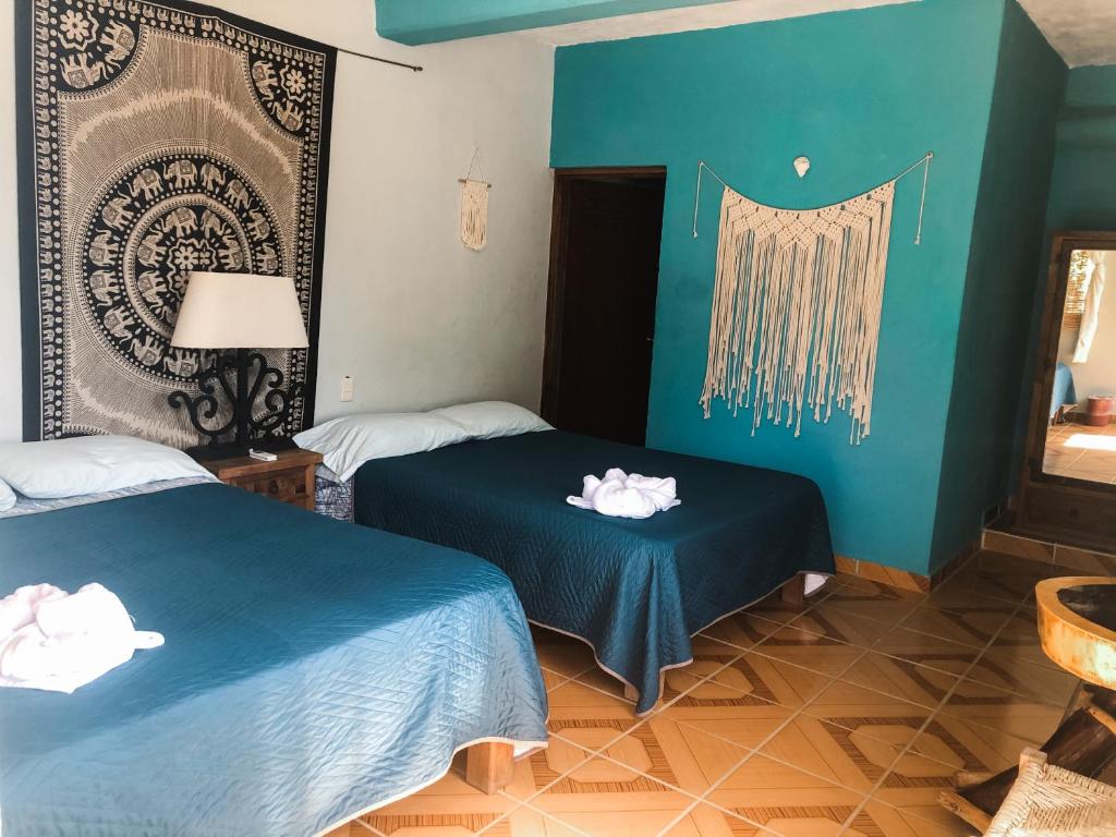 Postel nebo postele na pokoji v ubytování Colibri Hotel