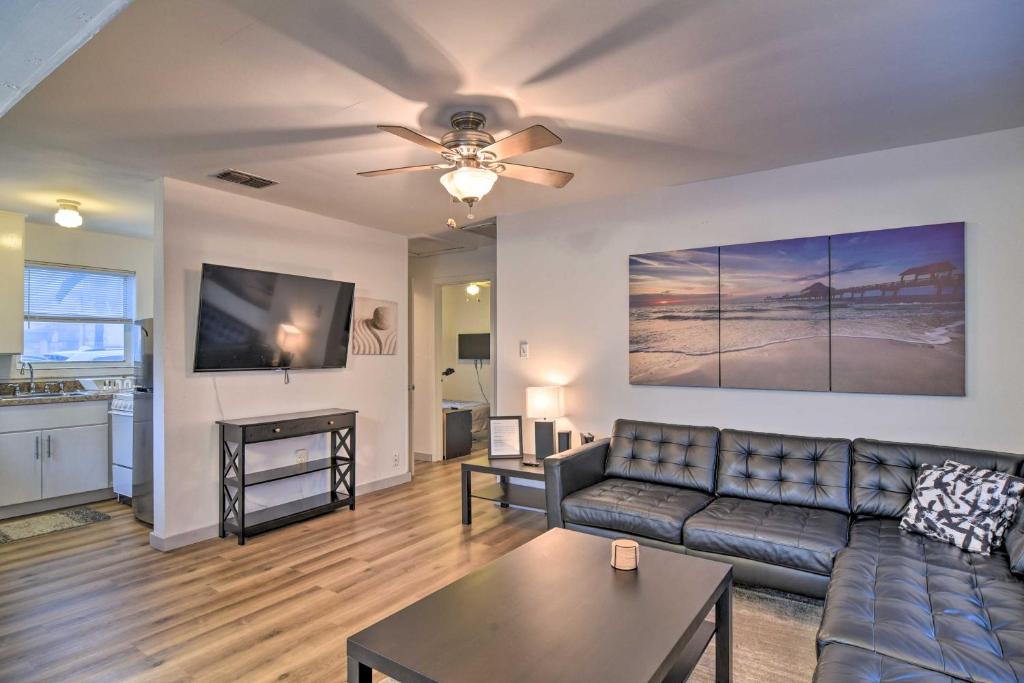 a living room with a couch and a ceiling fan at Sun-Soaked Coastal Hideaway - Steps to Beach! in Clearwater Beach