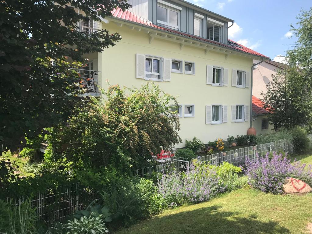 a house with a garden in front of it at Ferienwohnung an der Elz in Emmendingen