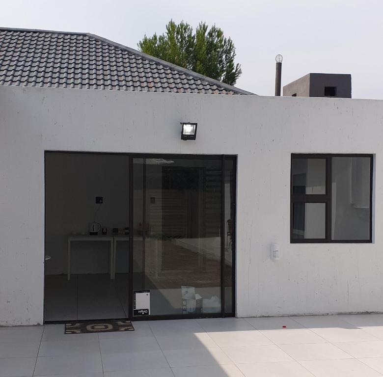 a white building with a large sliding glass door at Casa Mo Boutique Guest House in Bloemfontein