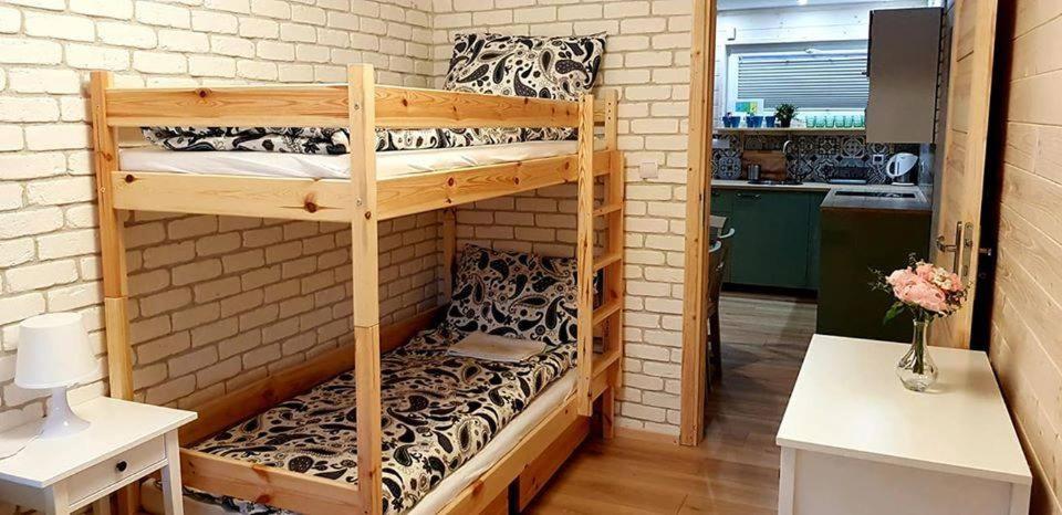 a couple of bunk beds in a room at Apartamenty przy winnicach in Bogács