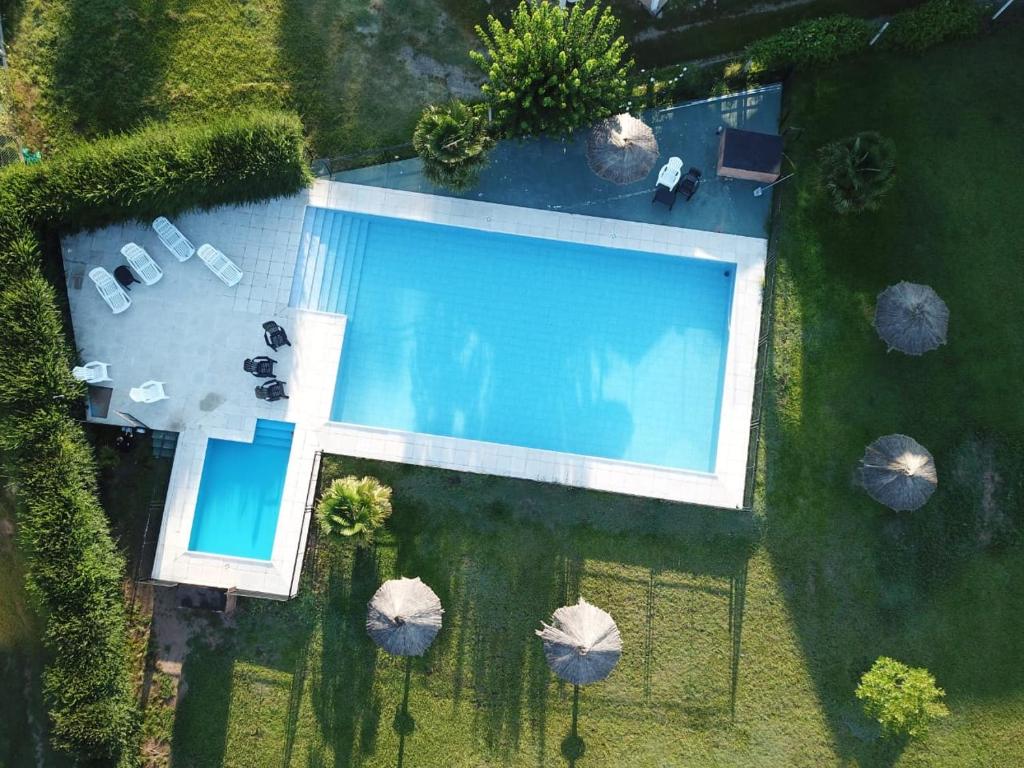 an overhead view of a large swimming pool with umbrellas at Hotel Aimara in Mina Clavero