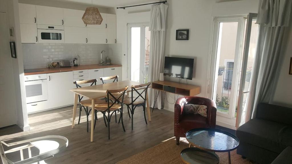 une cuisine et un salon avec une table et des chaises dans l'établissement Arca Noae, à Sète