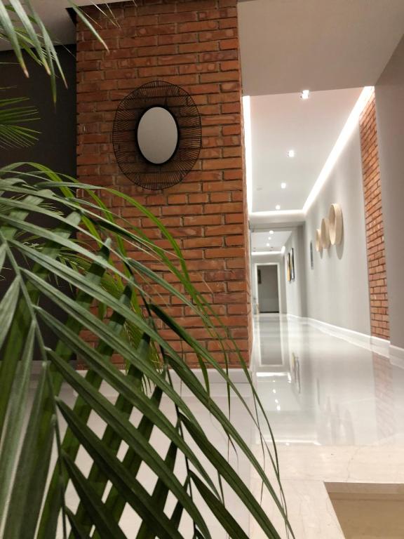 a brick wall in a hallway with a spiral staircase at Hotel Oresti Center in Tirana