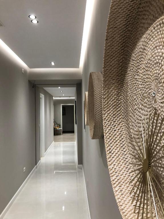 a hallway with a wall with a large painting on it at Hotel Oresti Center in Tirana