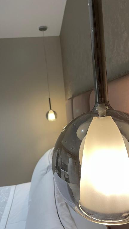 a close up of a light on top of a bed at Hotel Oresti Center in Tirana