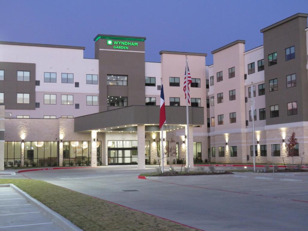 un aparcamiento vacío frente a un edificio en Wyndham Garden College Station en College Station