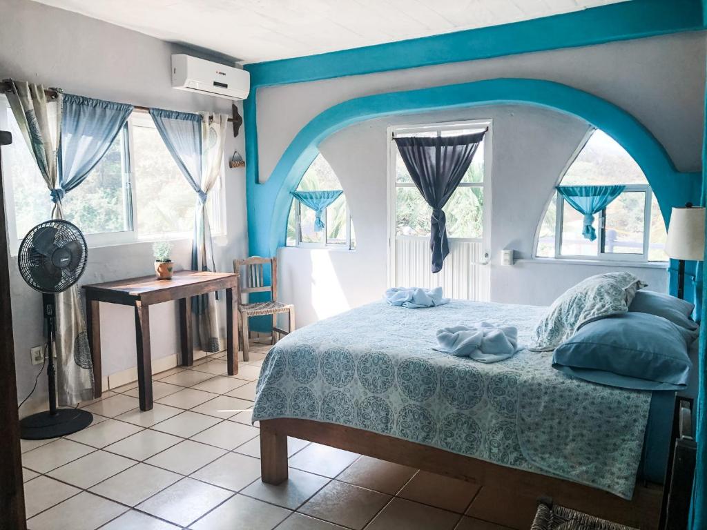 Postel nebo postele na pokoji v ubytování Colibri Hotel