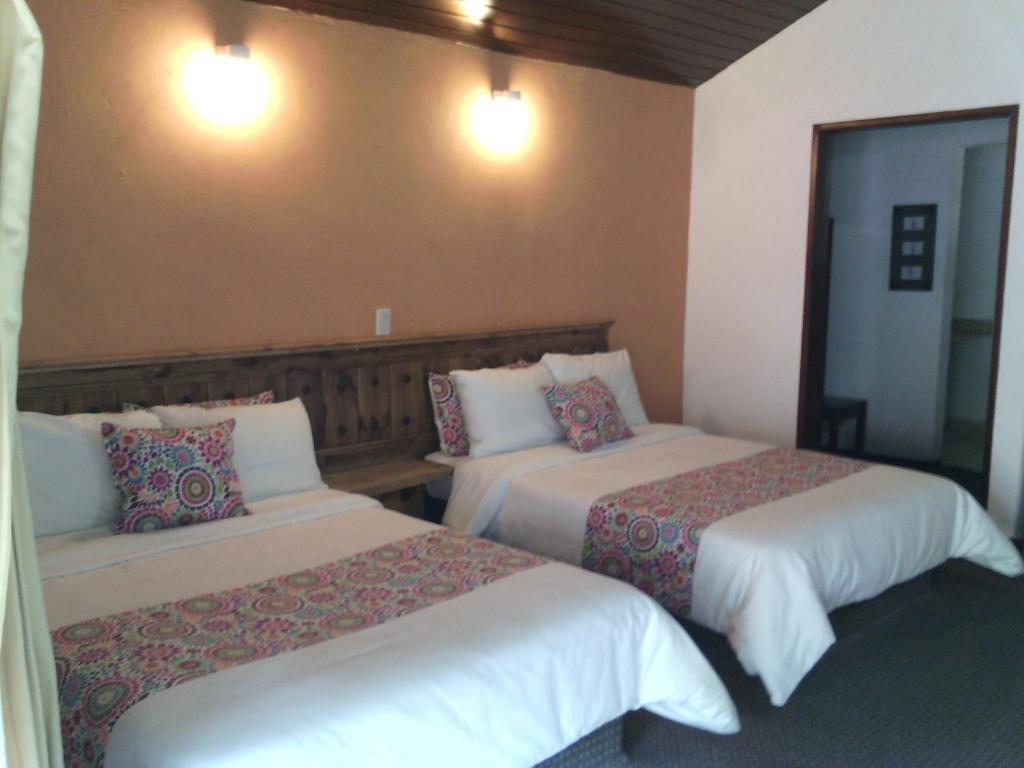 Postel nebo postele na pokoji v ubytování Hotel Chapala Country