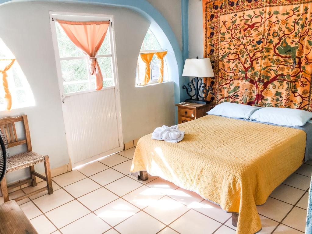Postel nebo postele na pokoji v ubytování Colibri Hotel