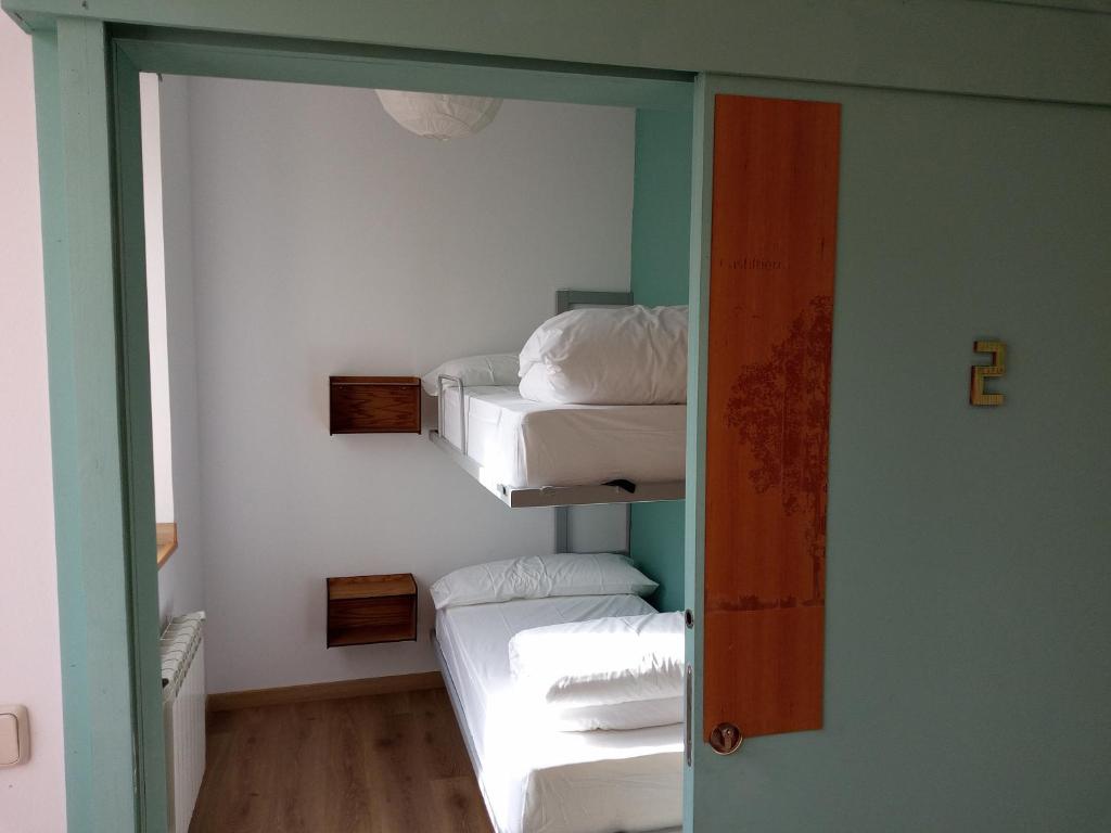 A bed or beds in a room at Albergue Fresno de Cantespino - La Tormenta