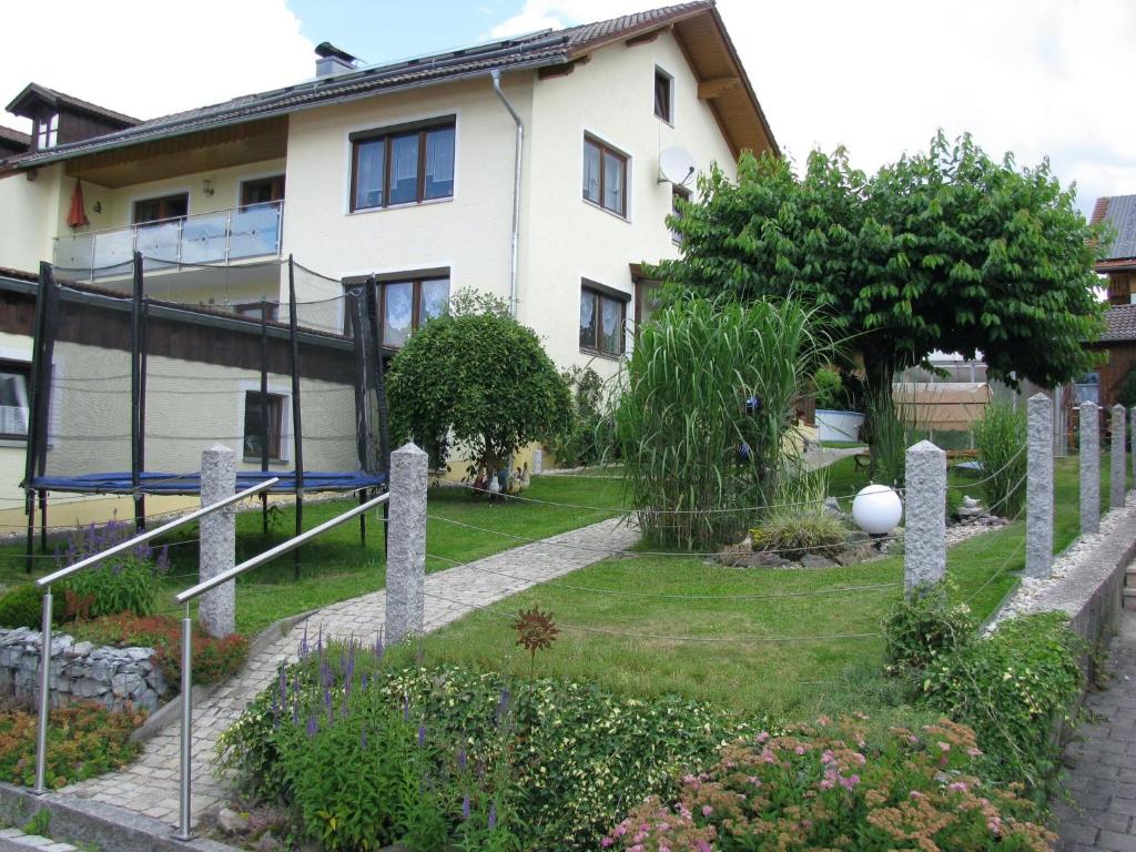 a house with a playground in front of it at Apartment in the Bavarian Forest with balcony in Drachselsried