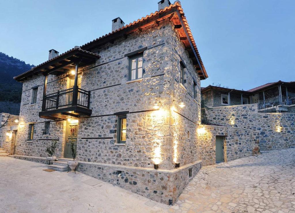 a large stone building with a balcony on it at Armonia Hotel in Kefalari