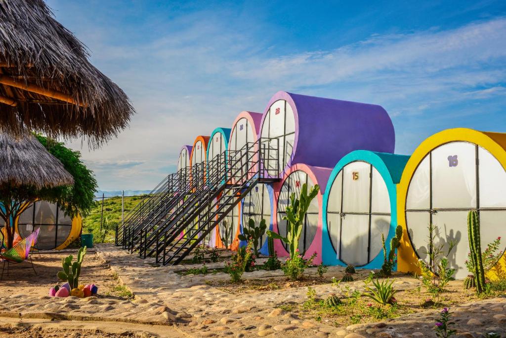 a building with colorful doors and stairs on the beach at Tubo Hotel La Tatacoa in Villavieja