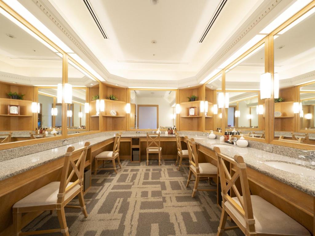 a large bathroom with a long row of sinks and mirrors at Nagoya Marriott Associa Hotel in Nagoya