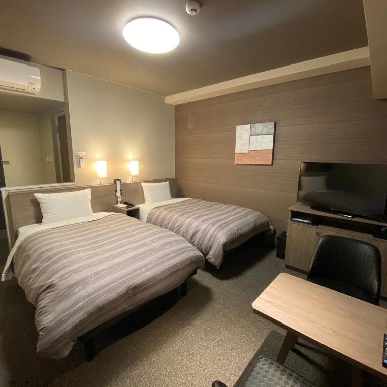 Postel nebo postele na pokoji v ubytování Route Inn Grantia Tokai Spa&Relaxation