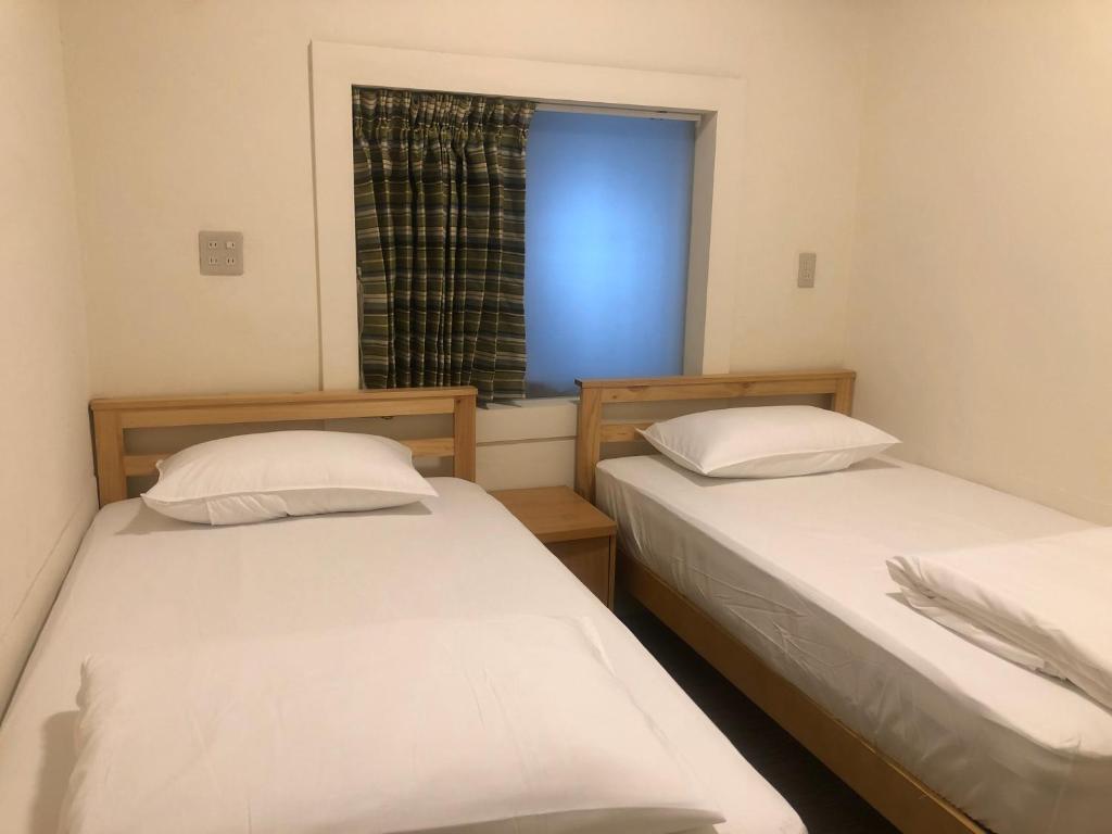Postel nebo postele na pokoji v ubytování Simple Walk Guest House 小公寓