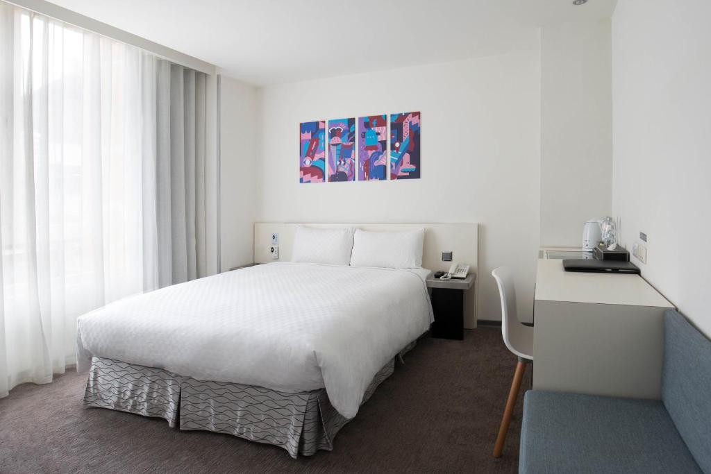 Postel nebo postele na pokoji v ubytování CityInn Hotel Taipei Station Branch II