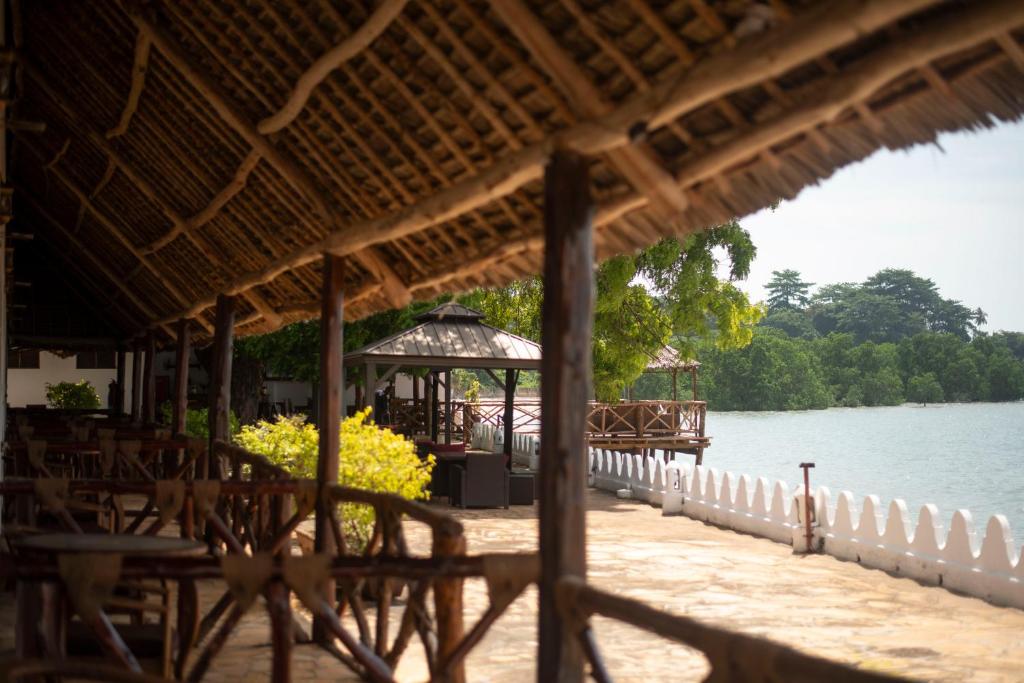 a pier with a gazebo and the water at Sea View Beach Hotel in Zanzibar City