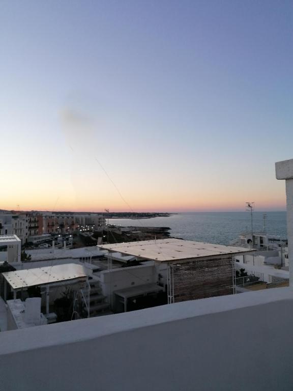 a view of the ocean from a rooftop of a building at FONTEblu B&B in Polignano a Mare
