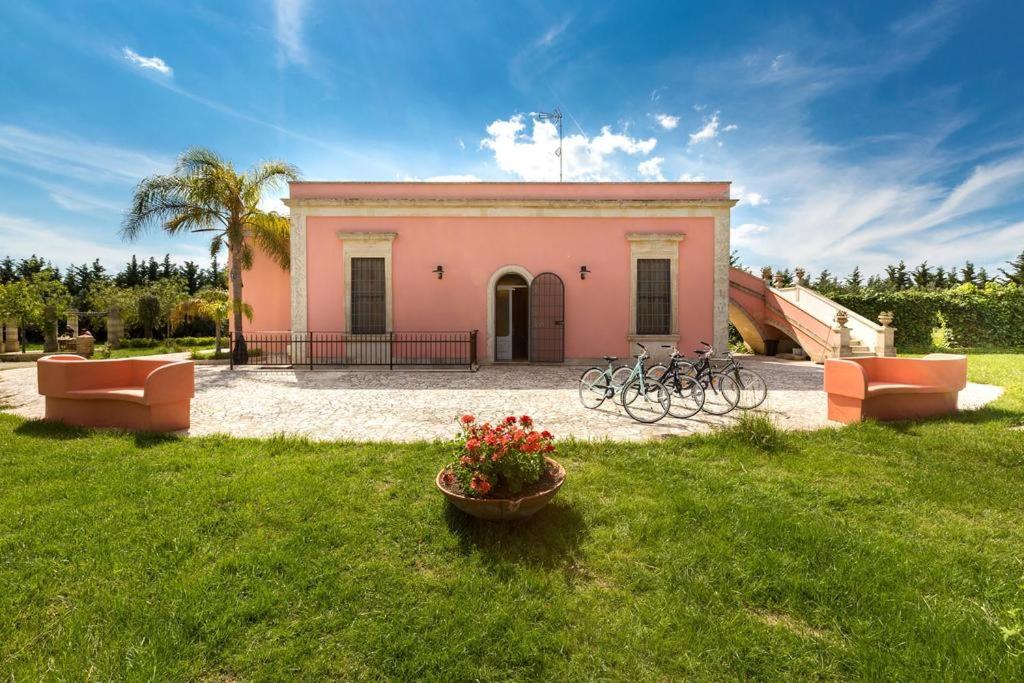 ein Gebäude mit zwei Fahrrädern auf einem Hof in der Unterkunft Villa I Giardini di Marzo in Guagnano