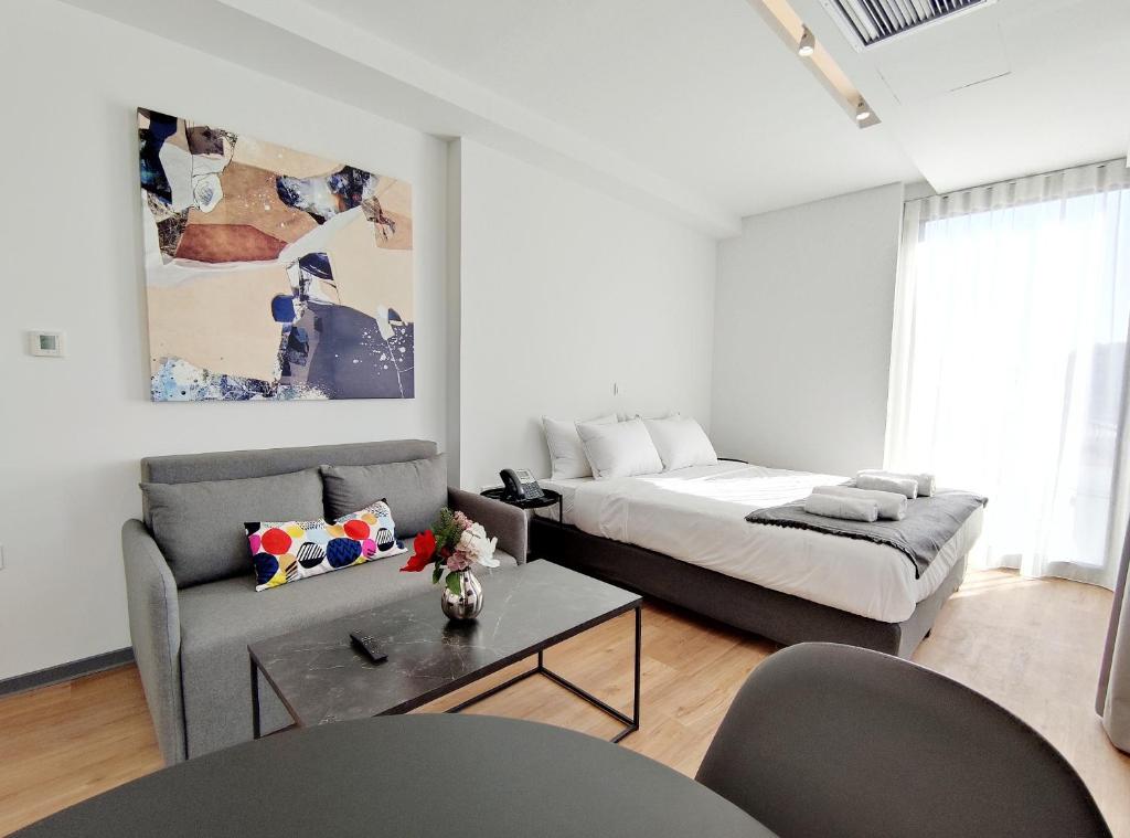 salon z łóżkiem i kanapą w obiekcie Verde Apartments w Atenach
