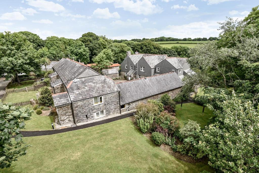 an aerial view of a large house with a yard at Lower Trengale Farm Holiday Cottages in Liskeard