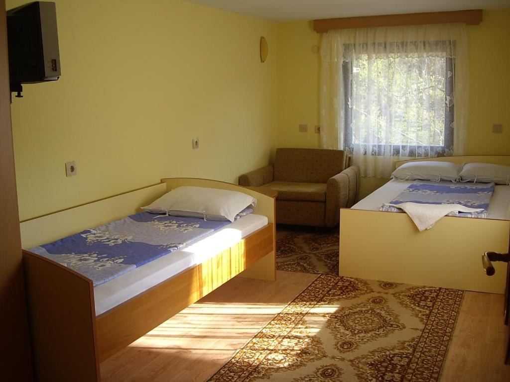 a small room with two beds and a couch at Guest House Rusalka in Shipkovo
