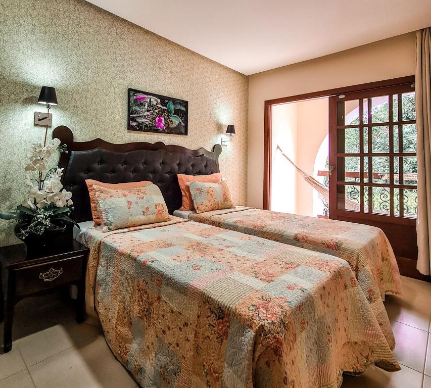 Cama ou camas em um quarto em Terra dos Diamantes Hotel