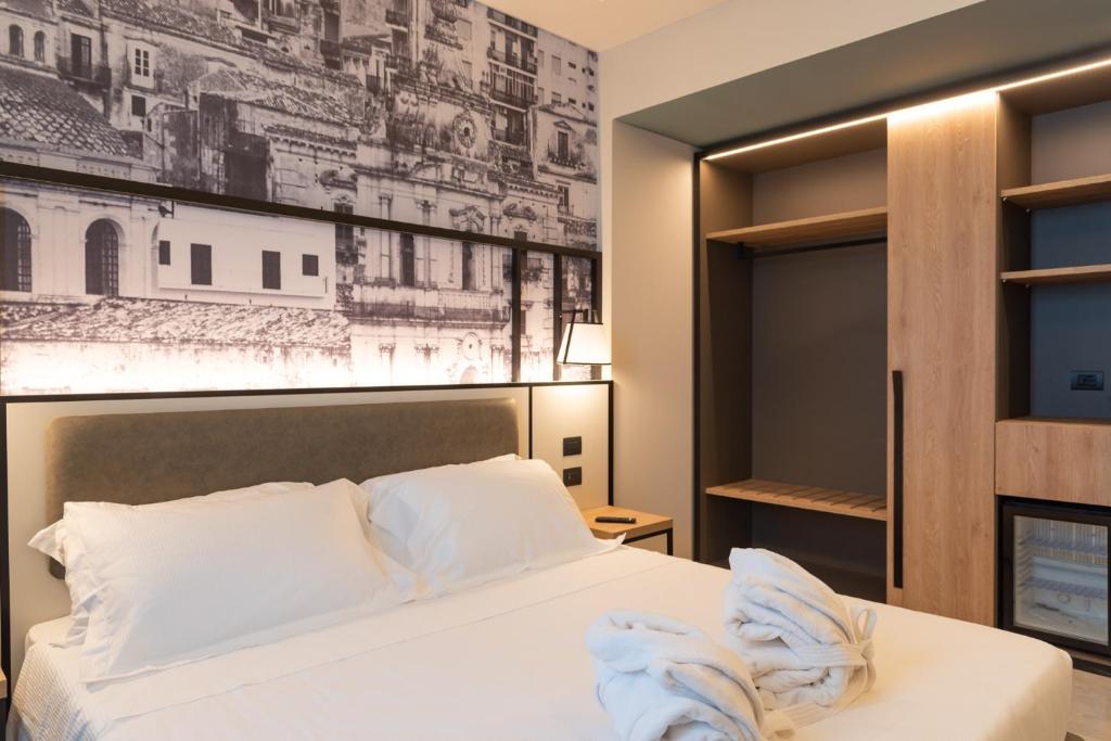 Postel nebo postele na pokoji v ubytování Modica Boutique Hotel