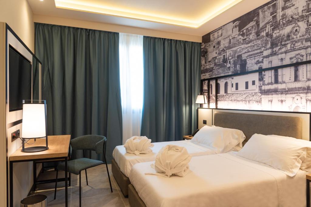 Postel nebo postele na pokoji v ubytování Modica Boutique Hotel