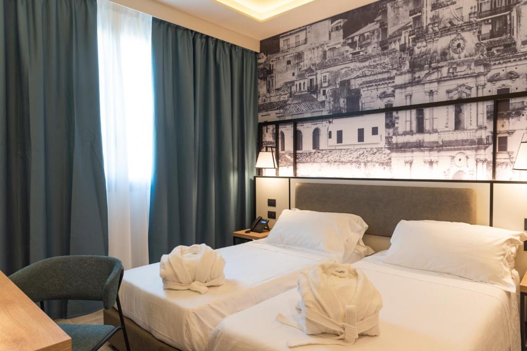 Postel nebo postele na pokoji v ubytování Modica Boutique Hotel