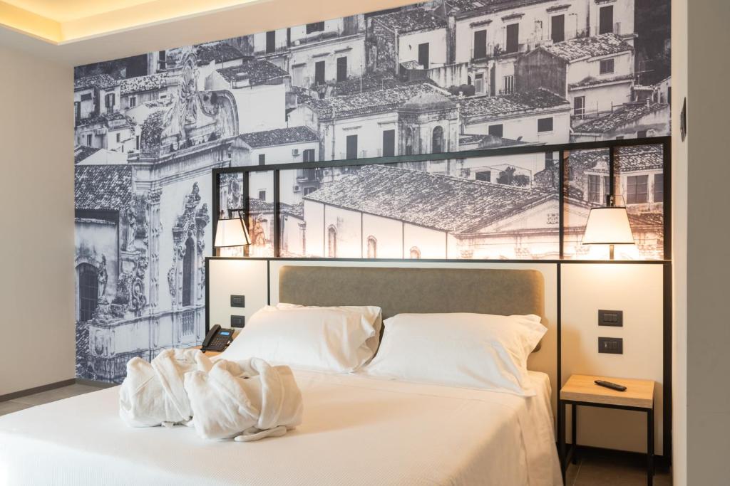 Postel nebo postele na pokoji v ubytování Modica Boutique Hotel