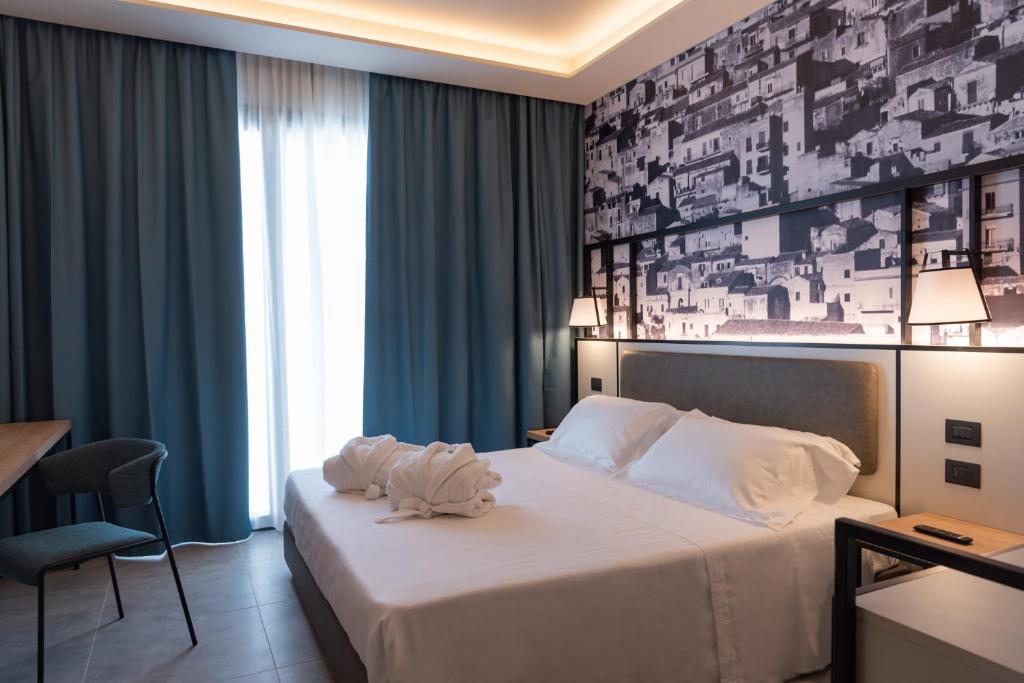 Postel nebo postele na pokoji v ubytování Modica Boutique Hotel
