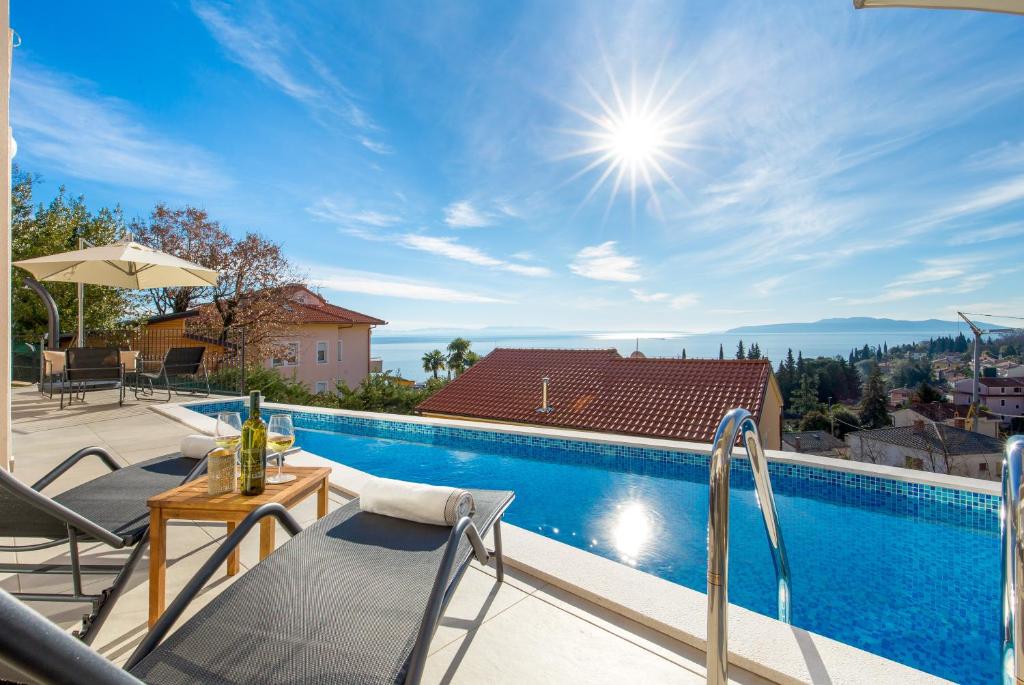 a villa with a swimming pool and a patio at Villa Ines in Ičići