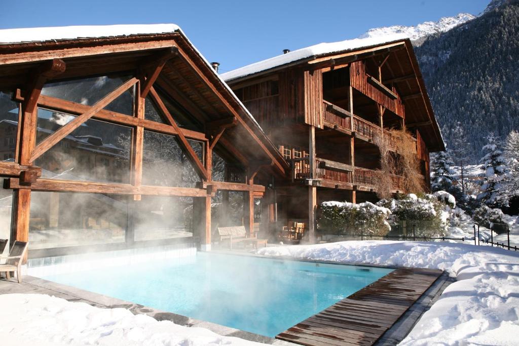 a house with a swimming pool in the snow at Le Hameau Albert 1er in Chamonix
