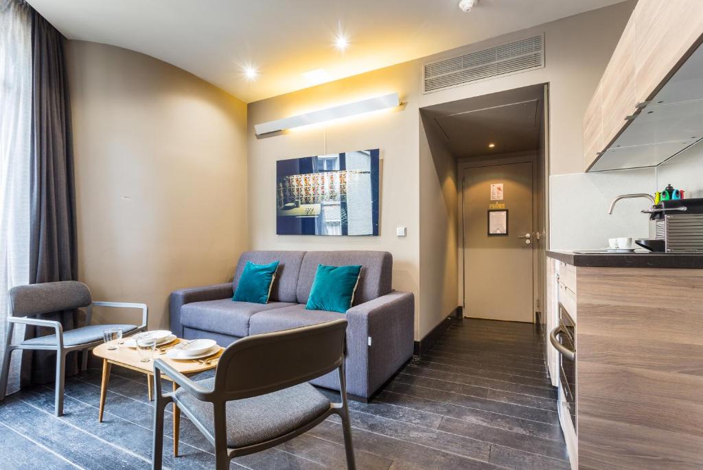 uma sala de estar com um sofá e uma mesa em CMG Suite Deluxe- 44 em Paris