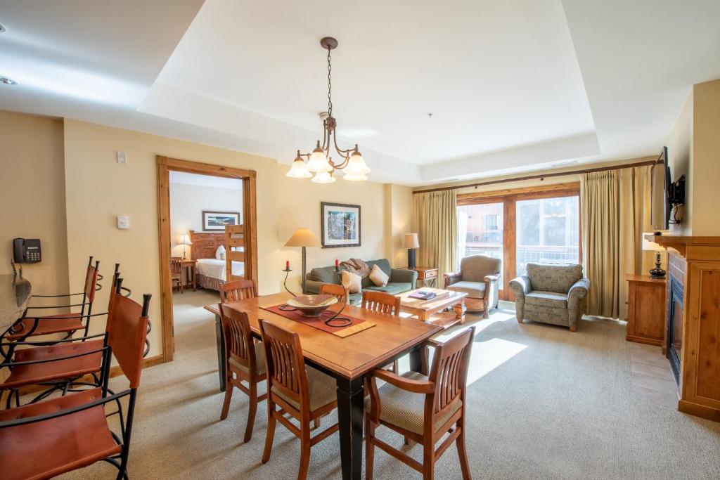a dining room and living room with a table and chairs at Kid-Friendly 2 bedroom 3 bathroom condo - Slopeside condo in Crested Butte