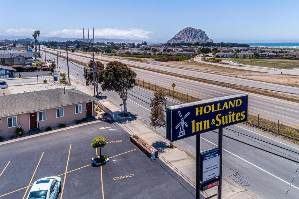 a sign for a hollywood inn suites next to a highway at Holland Inn & Suites in Morro Bay