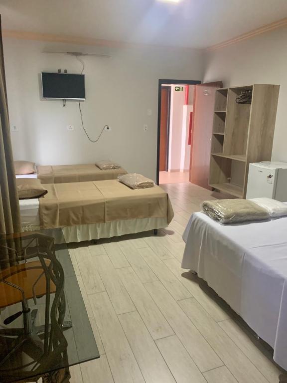 Postel nebo postele na pokoji v ubytování Hotel Paradizzo