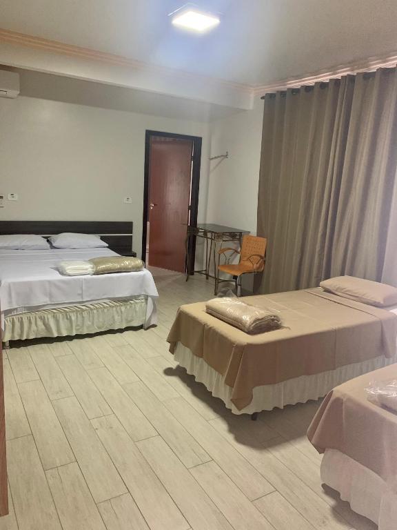Postel nebo postele na pokoji v ubytování Hotel Paradizzo
