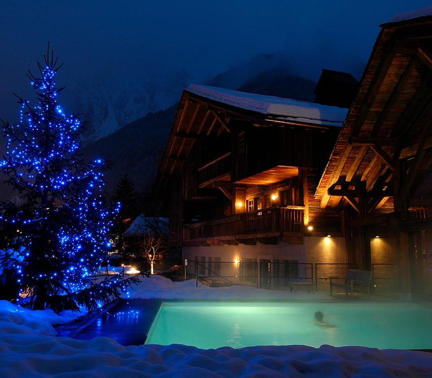 a christmas tree with blue lights next to a building at Le Hameau Albert 1er in Chamonix