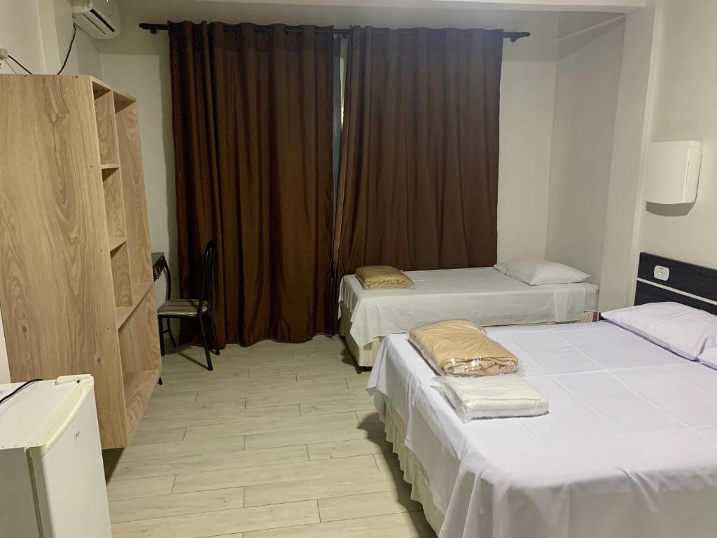 Postel nebo postele na pokoji v ubytování Hotel Paradizzo