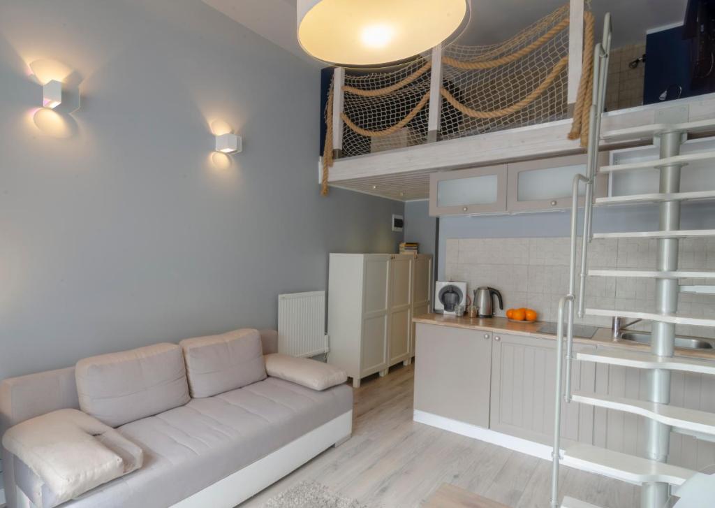 a living room with a couch and a bunk bed at Holiday Home SLAVIA NEW 012 in Międzyzdroje