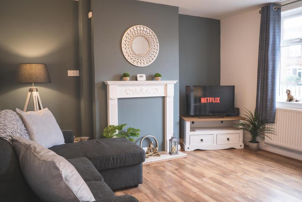 uma sala de estar com um sofá e uma televisão em Stunning 3-Bed house in Chester by 53 Degrees Property, ideal for Contractors & Families, FREE Parking - Sleeps 7 em Chester