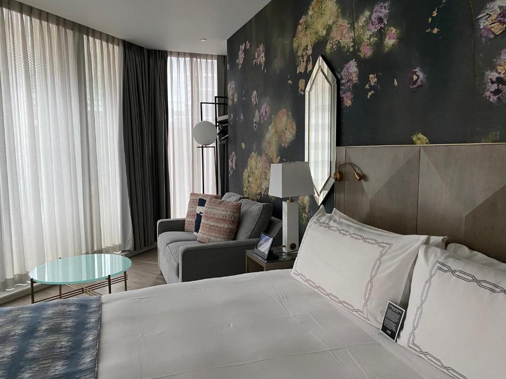 a bedroom with a bed and a living room at EXchange Hotel Vancouver in Vancouver