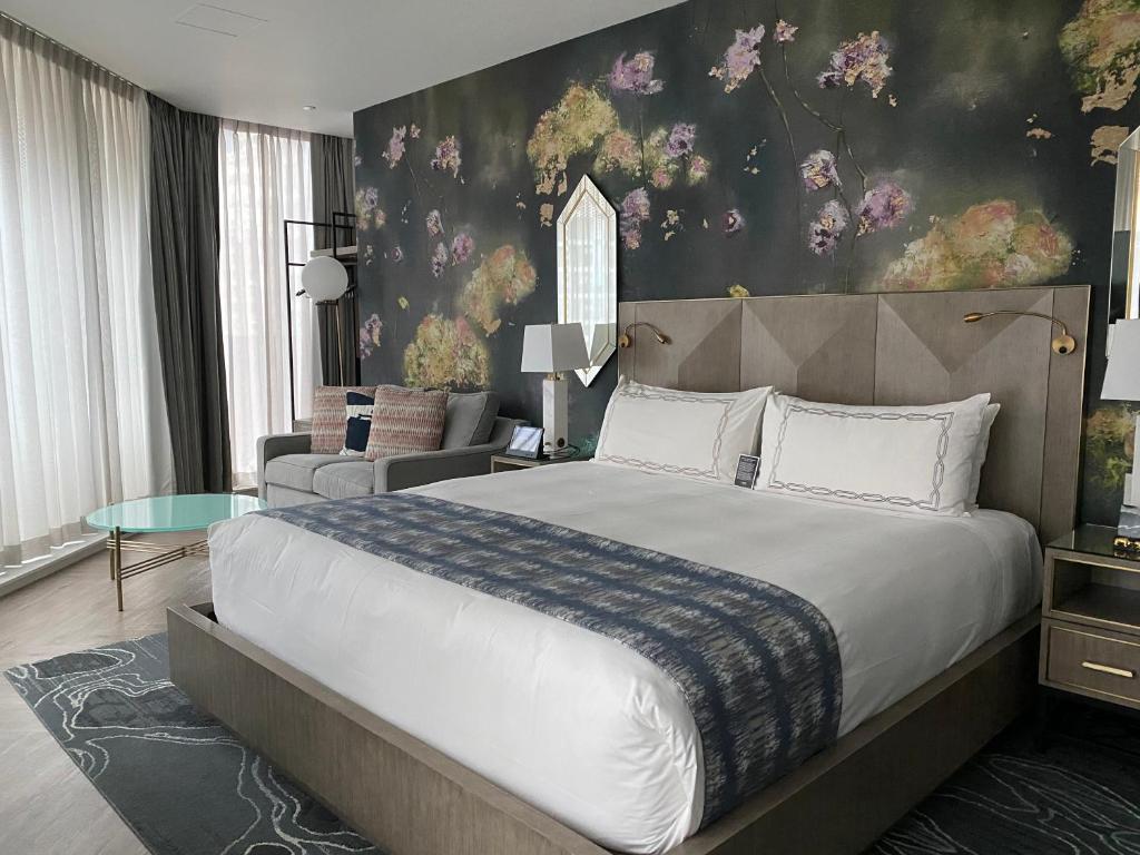 a bedroom with a large bed and a living room at EXchange Hotel Vancouver in Vancouver