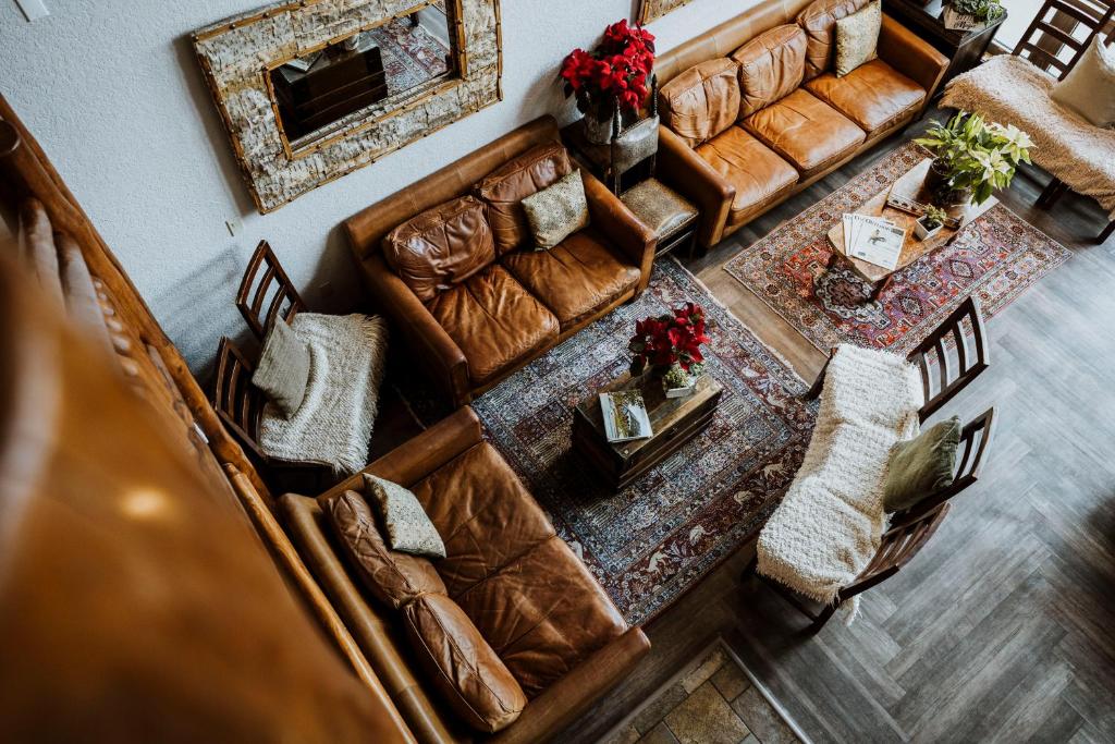 an overhead view of a living room with leather furniture at A Bear and Bison Country Inn in Canmore