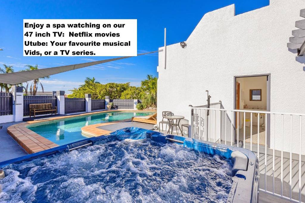 a swimming pool in front of a house at Aaron Motel in Gladstone